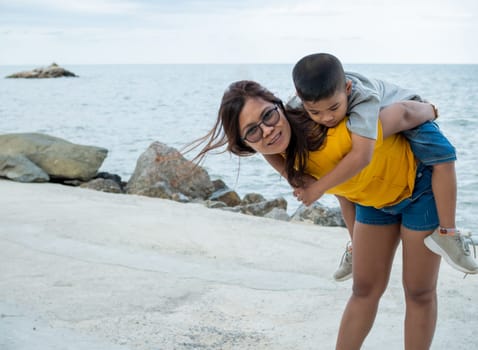 Portrait of mother and son on a sea background.