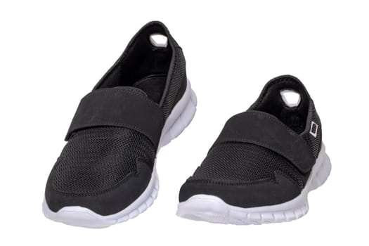 Mans black shoes. Close-up of a pair of black sneakers or sport shoes isolated on a white background. Elegant and trendy mens footwear. Macro.