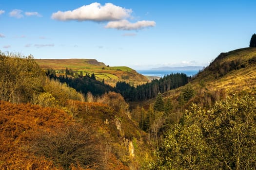 Panoramic view on the valley of Glenariff Forest Park in autumn colours with Scotland shore in far distance, Count Antrim, Northern Ireland