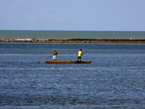 porto seguro, bahia / brazil - july 20, 2010: fishermen are seen in a small boat on the waters of the Buranhem river in the city of Porto Seguro, in southern Bahia.