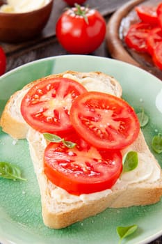 Open sandwich with fresh vine tomatoes and basil