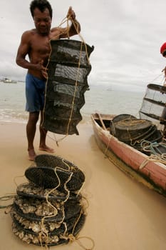 santa cruz cabralia, bahia / brazil - december 13, 2010: fisherman is seen transporting oysters from a breeding site on Coroa Vermelha beach in the city of Santa Cruz Cabralia.....