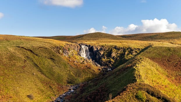 Beautiful waterfall and stream in the valley of Glenariff Forest Park in autumn colours, Count Antrim, Northern Ireland