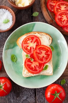 Open sandwich with fresh vine tomatoes and basil