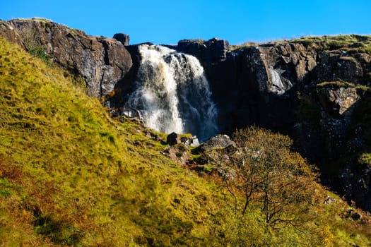 Beautiful waterfall and stream in the valley of Glenariff Forest Park in autumn colours, Count Antrim, Northern Ireland