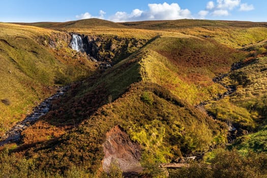 Beautiful waterfall and stream in the valley of Glenariff Forest Park in autumn colours, Count Antrim, Northern Ireland