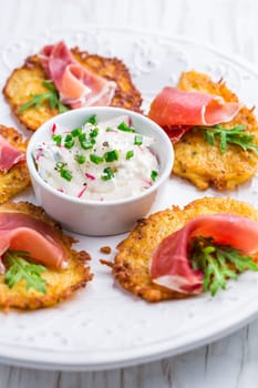 Potato pancake with prosciutto and dip of radishes cream cheese and chives. Healthy food concept.