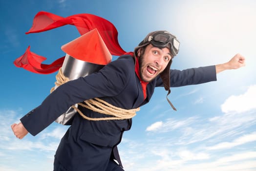 Businessman with homemade rocket and googles ready for a challenge