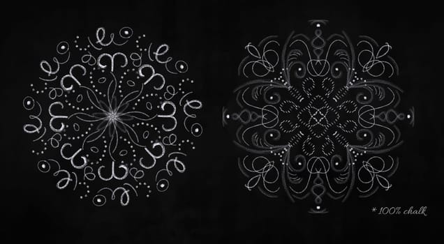 Set of white round chalk snowflakes on black chalkboard