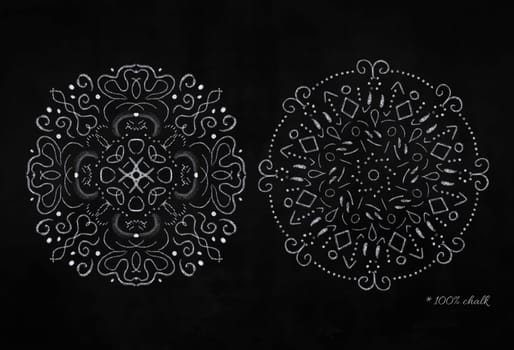 Set of white round chalk snowflakes on black chalkboard