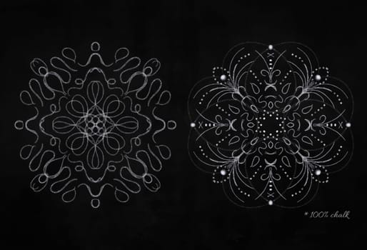 Set of white round chalk snowflakes on black chalkboard