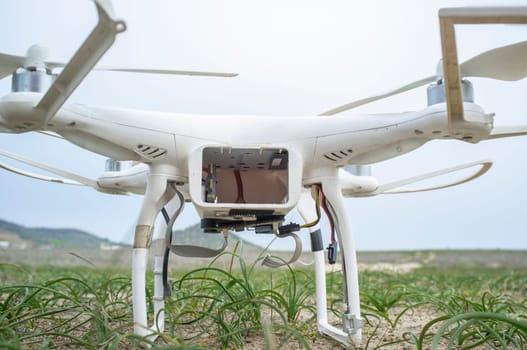 Landed drone with empty battery socket. Ground view