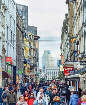 BRUSSELS, BELGIUM - OCTOBER 5, 2019: Central shopping street crowded with tourists, downtown architecture, evening cityscape view