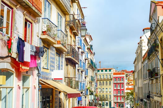 Old town cityscape, typical Portugese architecture, clotheslines on balconies, colorful tiled facades, Lisbon, Portugal