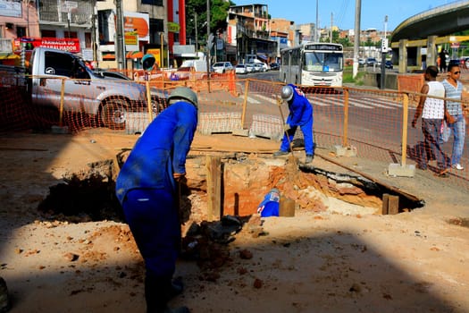 salvador, bahia / brazil - december 5, 2013: worker is building a walkway in the city of Salvador...