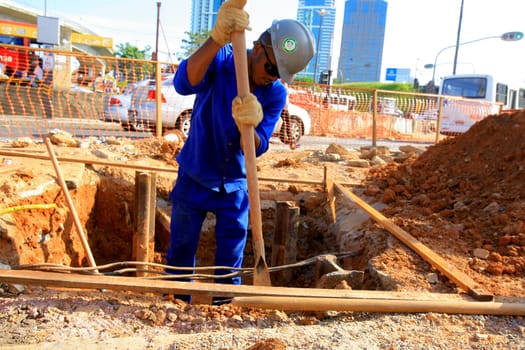salvador, bahia / brazil - december 5, 2013: worker is building a walkway in the city of Salvador...