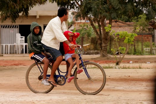 eunapolis, bahia / brazil - august 19, 2010: family is seen transported on a bicycle in the city of Eunapolis, in southern Bahia...