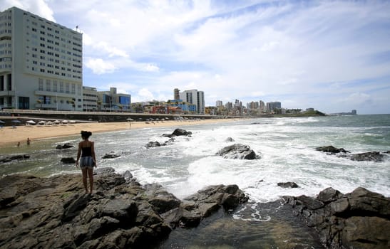 salvador, bahia / brazil - august 28, 2018: people are seen next to rocks on Barra beach in the city of Salvador.