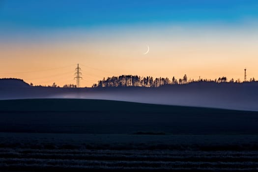 Rural countryside landscape after sunset with moon, Europe, Czech Republic