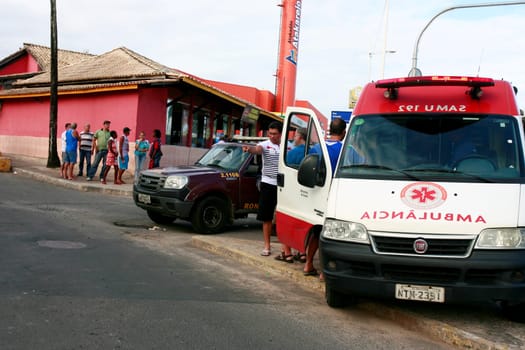 salvador, bahia / brazil - august 13, 2015: Ambulance of the Samu 192 provides average care to a person who fell into a hole in the Itapua neighborhood in the city of Salvador.