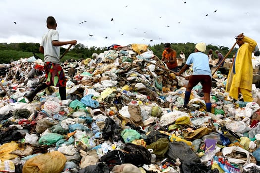 Itabuna, bahia / brazil - september 27, 2011: people are seen turning through the garbage to collect recycling material at the sanitary landfill in the city of Itabuna......