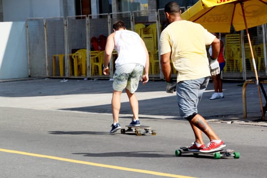 salvador, bahia / brazil - april 14, 2013: person is seen skateboarding on the street in the city of Salvador.