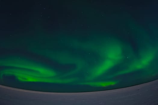 Northern Lights in the night sky. Northern Lights in the tundra.