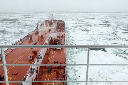 The feed of a ship sailing in the Arctic. Landscape of the Arctic from the deck of the tanker.