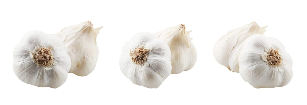 Close-Up Of Garlic Bulbs Against White Background.