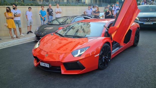 Monte-Carlo, Monaco - August 17, 2020: Beautiful Orange Lamborghini Aventador SV With The Doors Open, Italian Supercar Parked On The Casino Square In Monte-Carlo, Monaco, Europe .