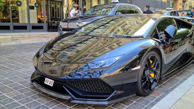 Monte-Carlo, Monaco - August 8, 2020: Black lamborghini Huracan Supercar Parked in Front Of The Hotel Hermitage In Monte-Carlo, Monaco, Europe. Close Up View.