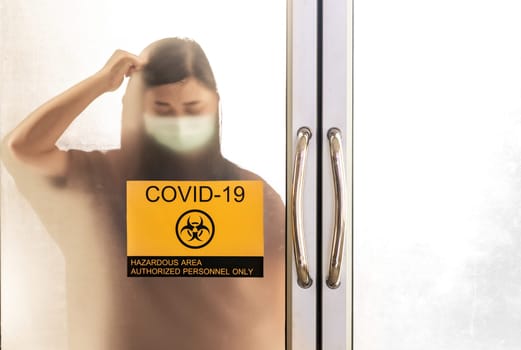 Signage of coronavirus COVID-19 quarantine zone and Silhouette of asian woman strain with her infection. Hospital health care and infection concept.