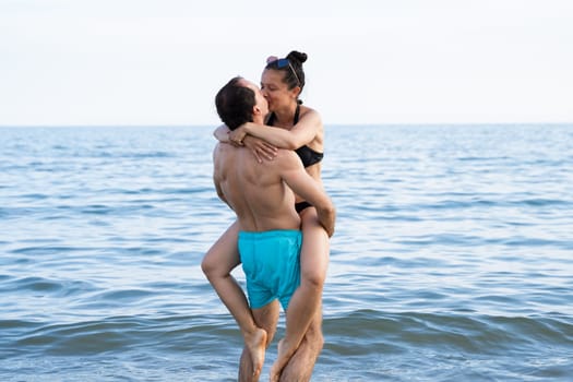 Lifting Woman At Beach At Sea In Summer