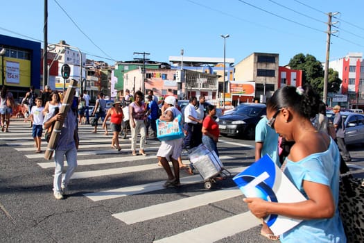 salvador, bahia / brazil - december 5, 2013: people are seen crossing the street in a pedestrian lane in the city of Salvador.