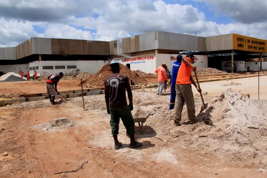 sao sebastiao do passe, bahia / brazil - september 4, 2013: workers are seen during construction of street paving in the city of Sao Sebastiao do Passe..