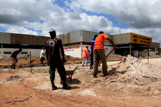 sao sebastiao do passe, bahia / brazil - september 4, 2013: workers are seen during construction of street paving in the city of Sao Sebastiao do Passe..