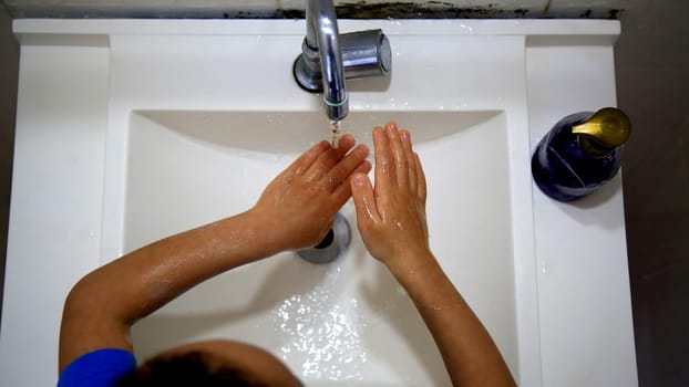 salvador, bahia / brazil - september 3, 2020: child is seen washing his hands in a bathroom sink in the city of Salvador.