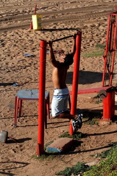 salvador, bahia / brazil - april 14, 2013: person doing physical activity in a street gym in the city of Salvador.