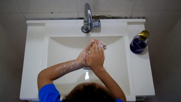 salvador, bahia / brazil - september 3, 2020: child is seen washing his hands in a bathroom sink in the city of Salvador.