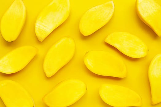Tropical fruit, Mango slices on yellow background. Top view