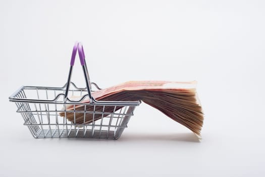 There is a large stack of bills on the grocery basket