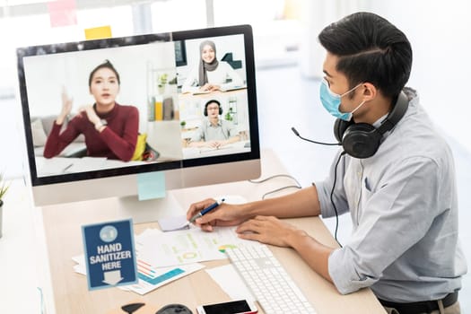 Asian businessman work from home office involved video conference meeting with corporate colleague for discuss and brainstorm distantly. This technology is popular after coronavirus COVID-19 spreading