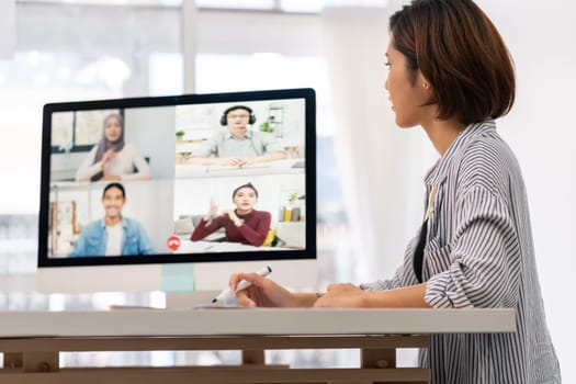 Asian businesswoman work from home office involved video conference meeting to corporate colleague for discuss and brainstorm distantly. This technology is popular after coronavirus COVID-19 spreading