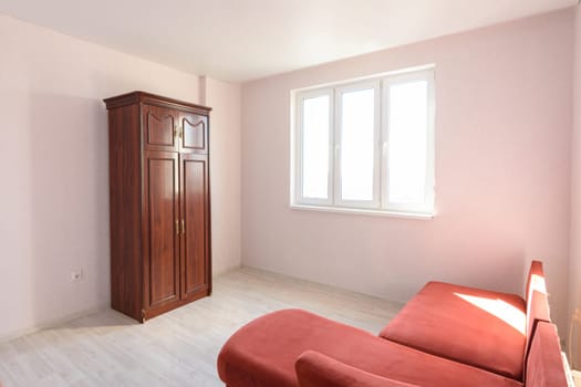 Interior of a non-residential room empty for sale with several pieces of furniture