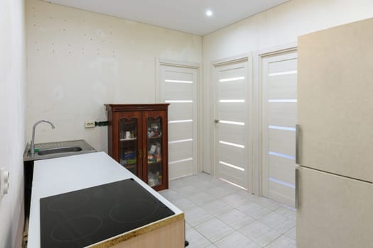 Kitchen interior with temporary poor furniture in a new building