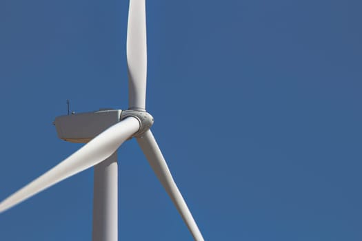 Close up, side view of a wind tower turbine electricity gererator, renewable energy source.