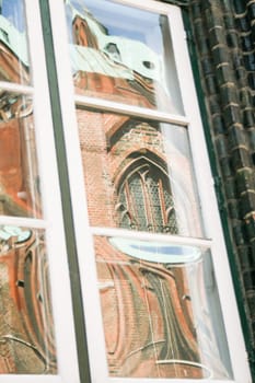 Church in the window. Reflection in old town of Lubeck - Germany