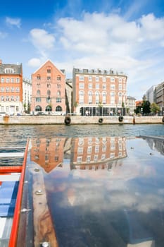 Colored Danish Homes with reflection. View from a Boat