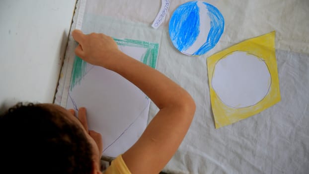 salvador, bahia / brazil - september 3, 2020: child paints brazil flag with crayons at his home in the city of Salvador.