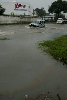 eunapolis, bahia / brazil - april 9, 2009: vehicle transits in flooded area on highway BR 101 in the city of Eunapolis, in southern Bahia..